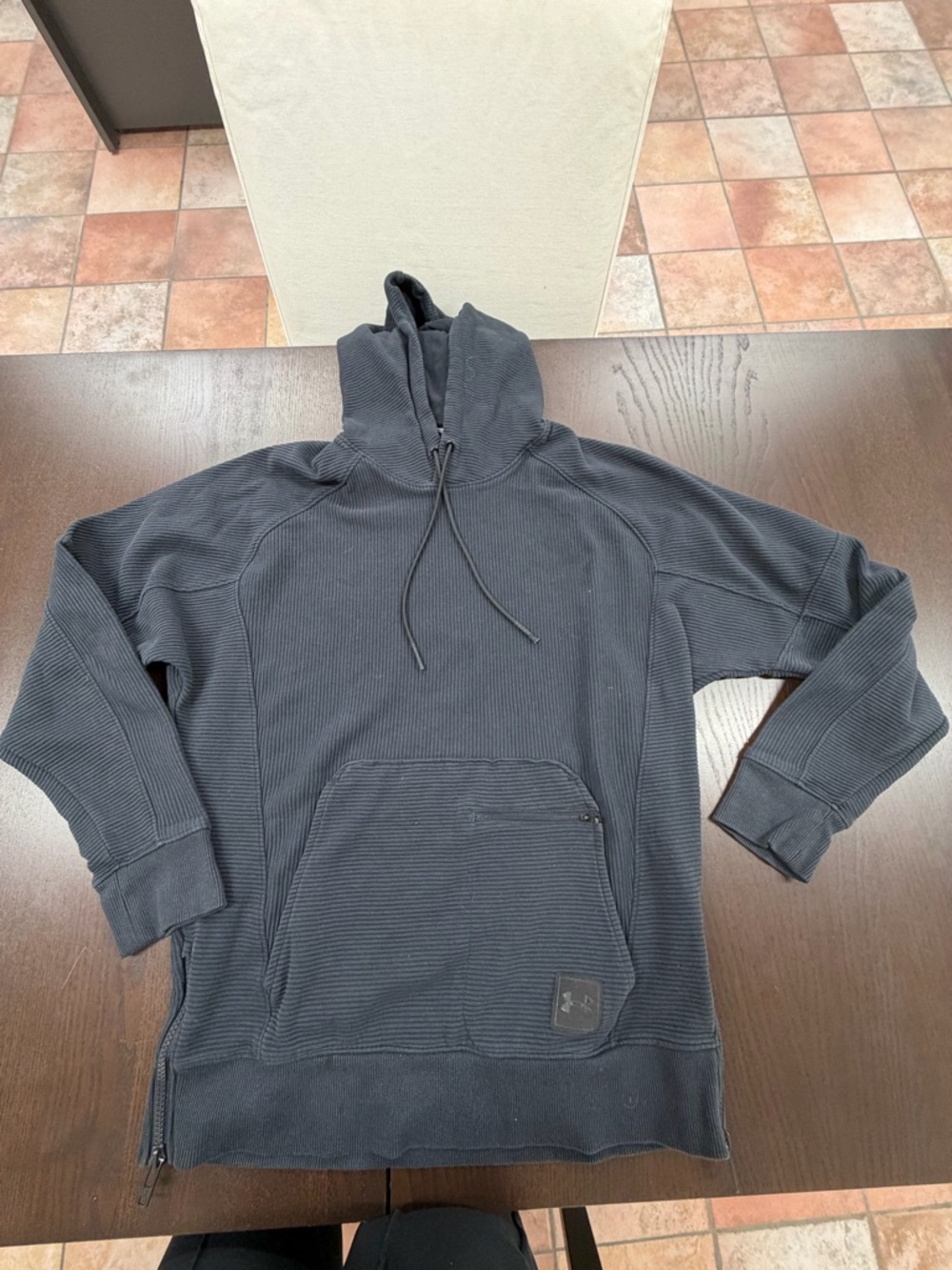 One small Under Armour hooded sweatshirt
